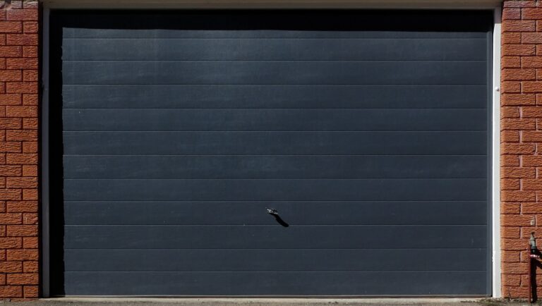 grey garage door on red brick wall
